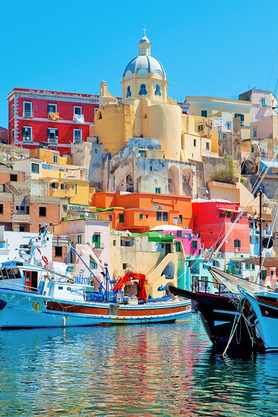 Island of Procida and its colorful village seen from a boat