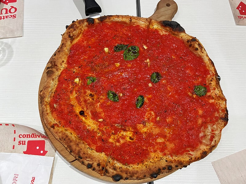A huge Neapolitan pizza marinara in a pizzeria