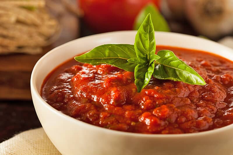 A bowl of Neapolitan ragu sauce with basil on he top