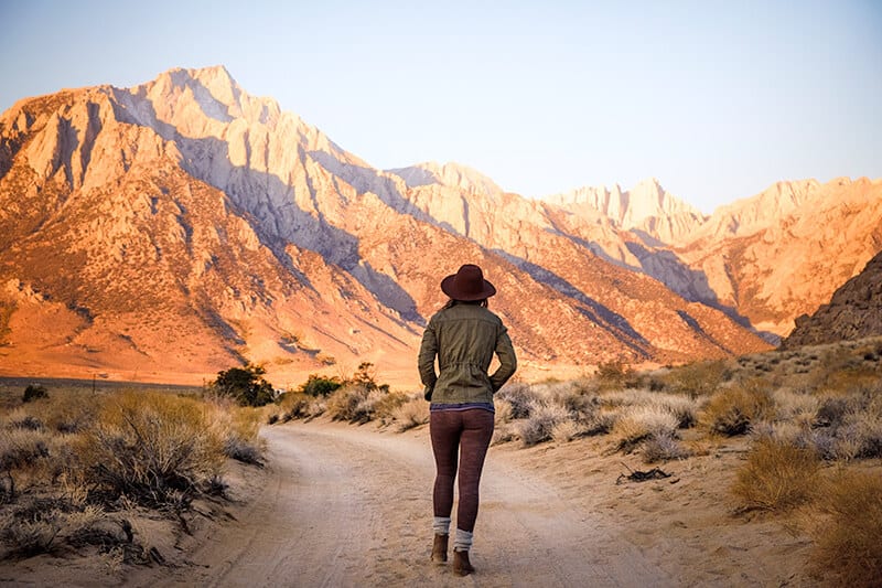 Girl walking on a dirt road in one of the Utah parks