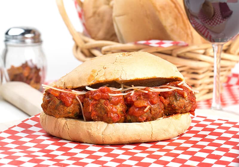 Huge sandwich with Italian meatballs and sauce on the table