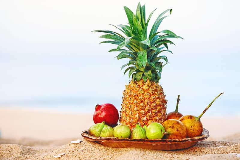 Plate of Hawaiian tropical fruit with a big pineapple in the middle