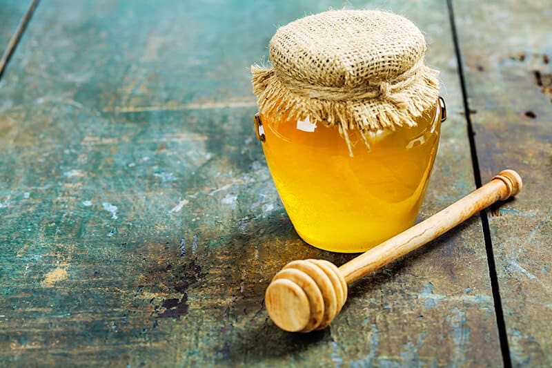 Jar of bright yellow lehua honey from Hawaii