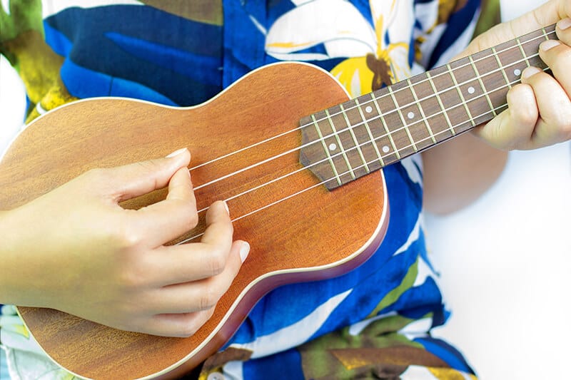 Hawaiian musician playing a traditional ukulele