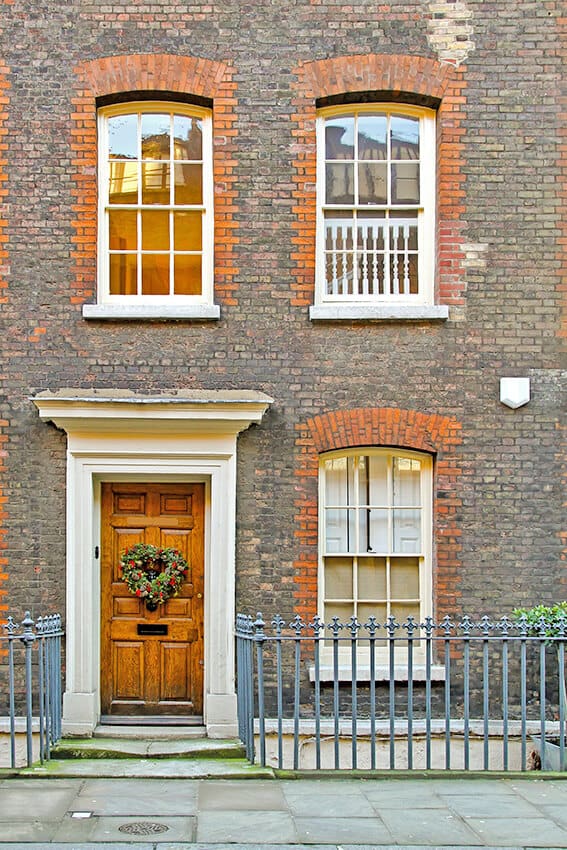 Brick building in London with a cute Christmas garland at the door