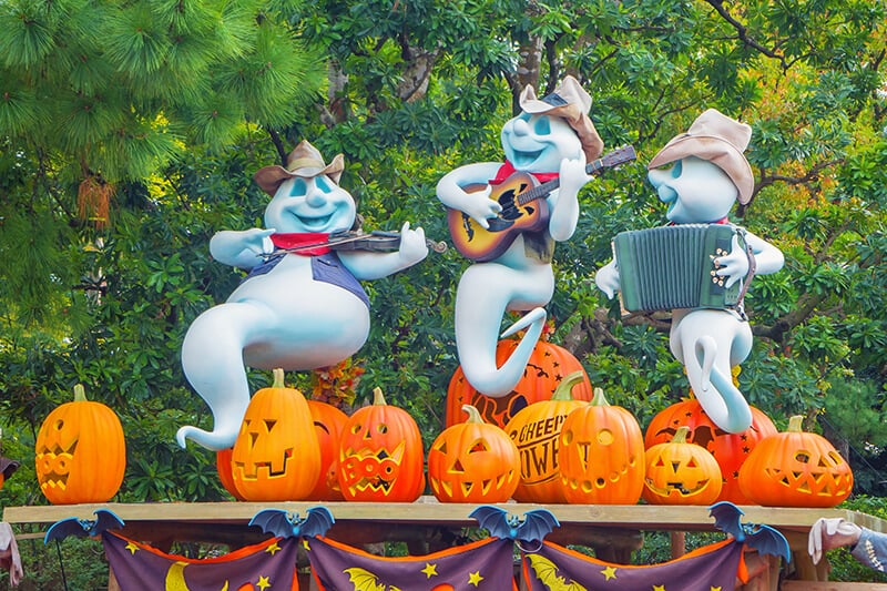 Halloween at Disney World: 3 ghosts playing music on a field of pumpkins