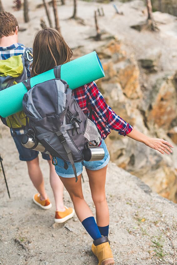 Couple hiking together on a mountain trail