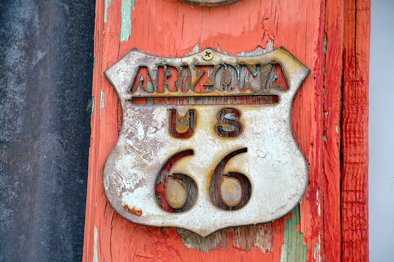 Arizona Route 66 metal plate on the wall of an old barn in a ghost town