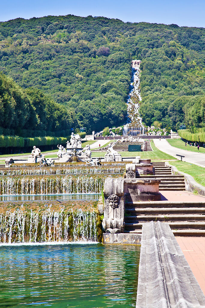 View of the English garden at Caserta Royal Palace with the waterfall in the background