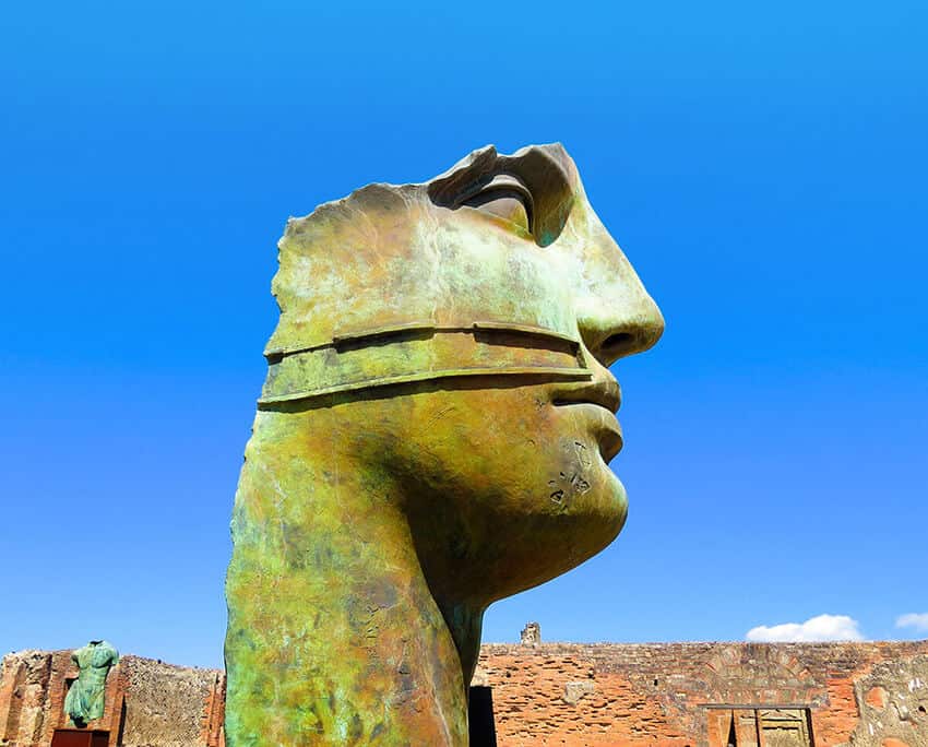 Pompeii statue depicting a face on a Pompeii day trip from Naples (Italy)