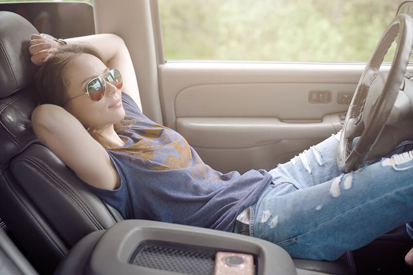 Girl sleeping in a car on the front seat