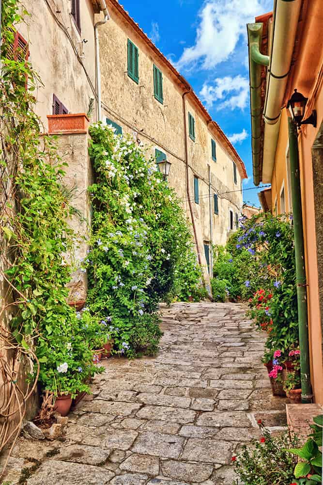 Cute Tuscan village full of flowers