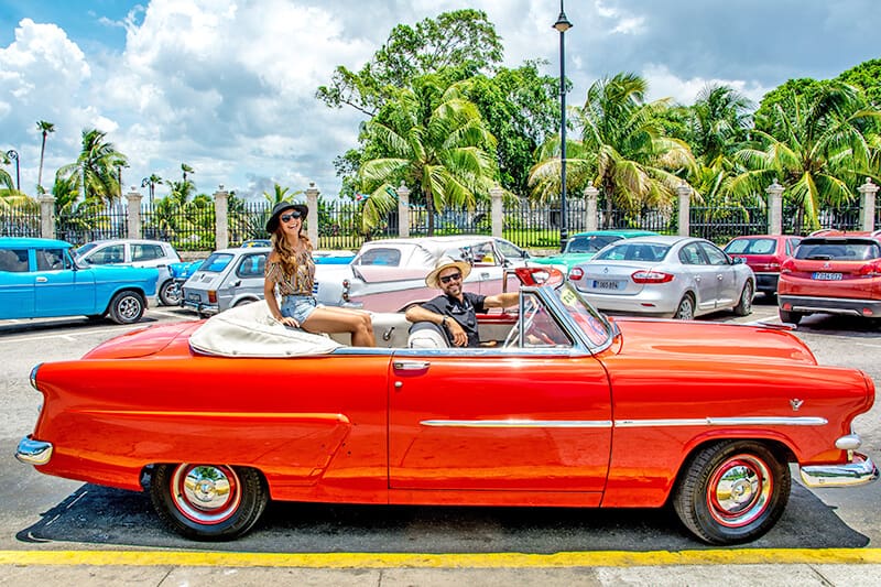 Couple in a vintage convertible in Miami Beach