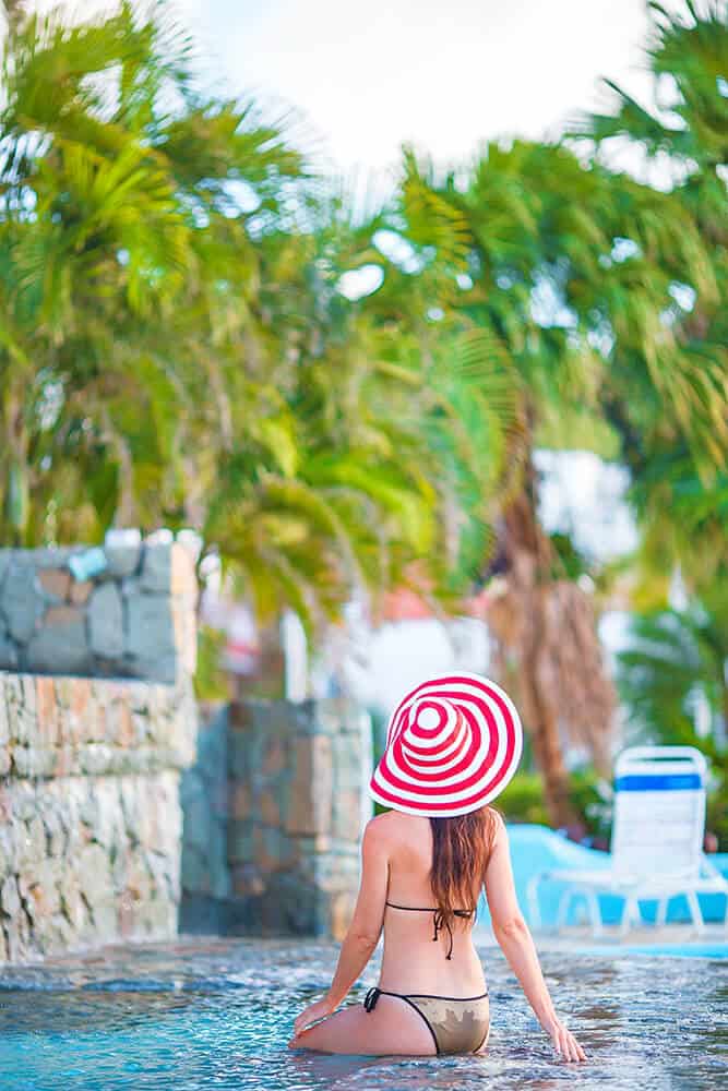 Young girl having her picture taken in a swimming pool in South Beach