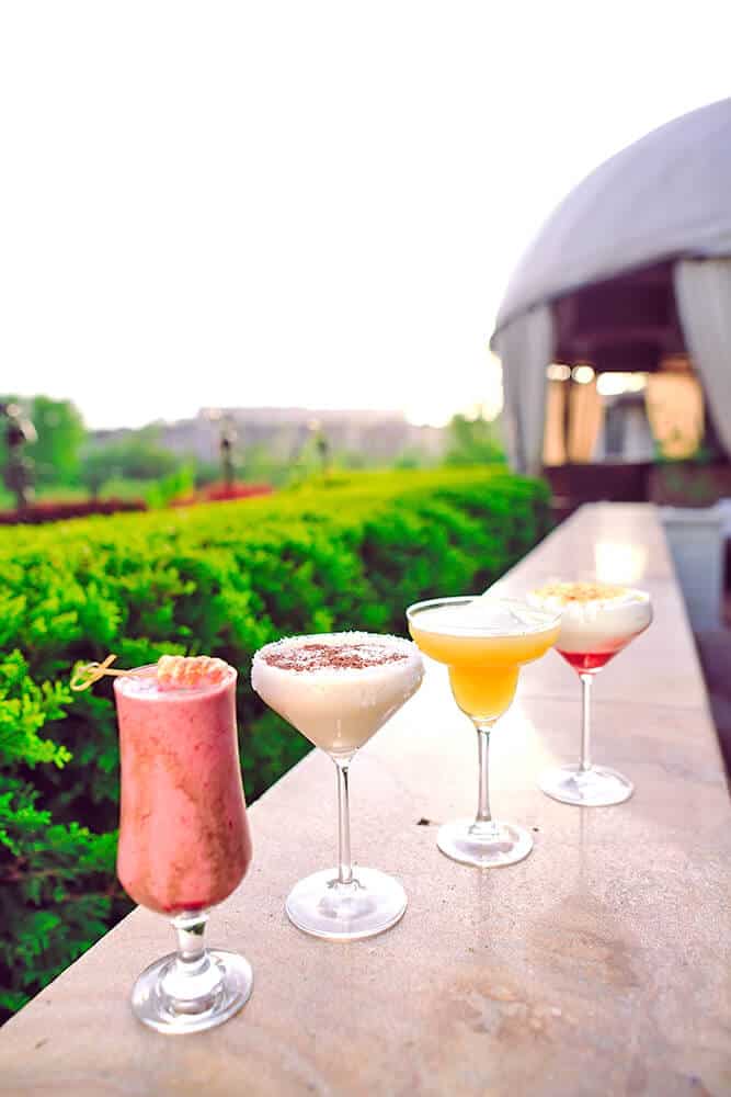 Fancy cocktails on the edge of a rooftop bar in Miami