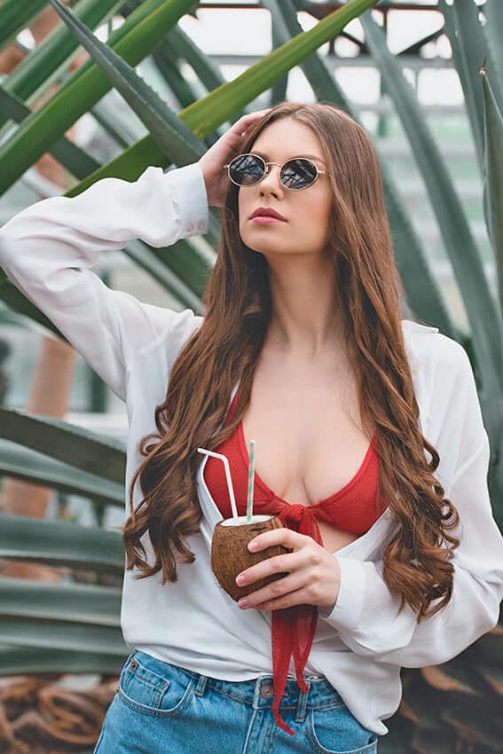 Girl drinking from a coconut in Hawaii