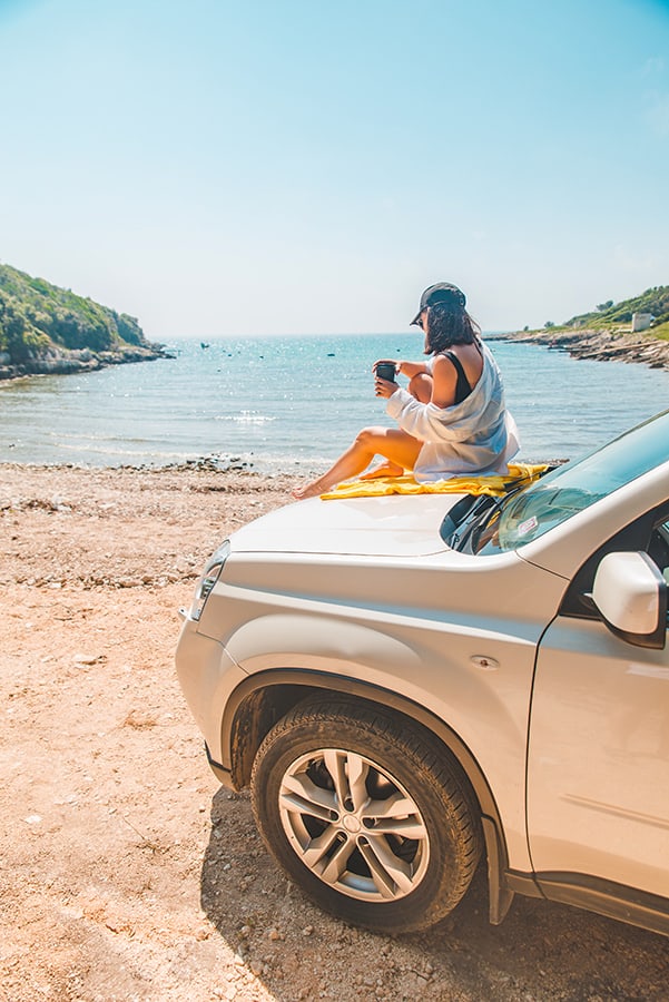 Girl on the hood of a car in Oahu