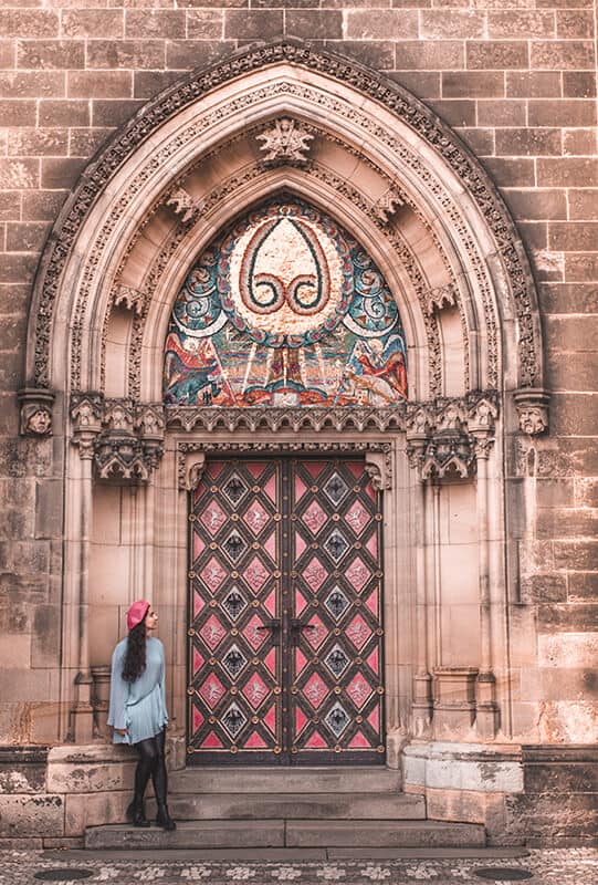 Girl sitting in front of a Church in Europe