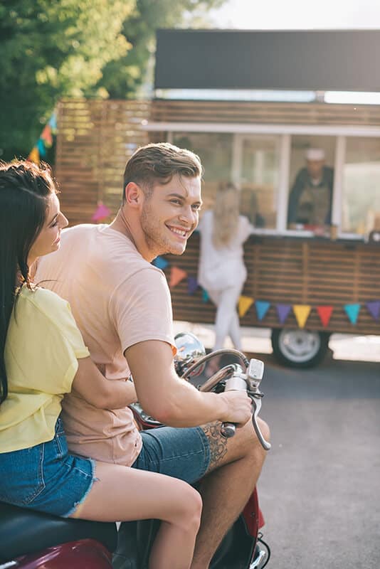 Couple on a vespa in Italy