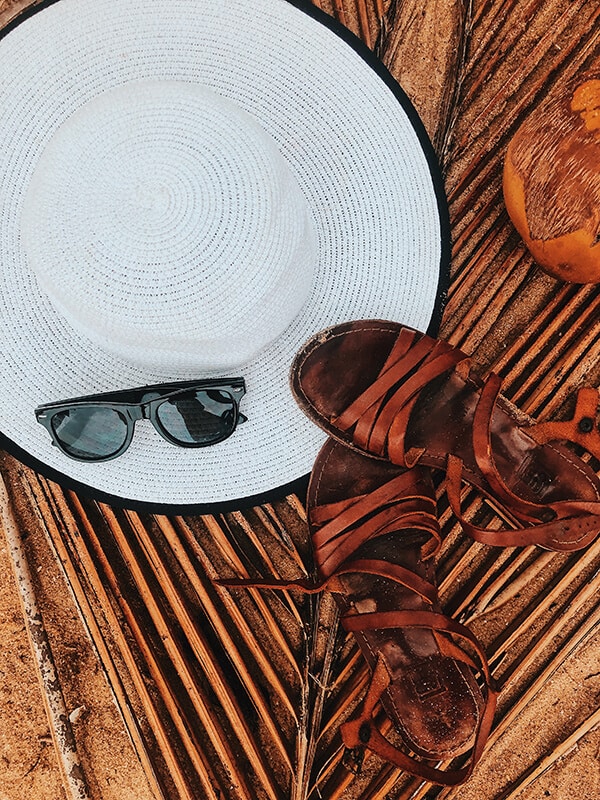 Leather sandals, sunglasses and a white hat