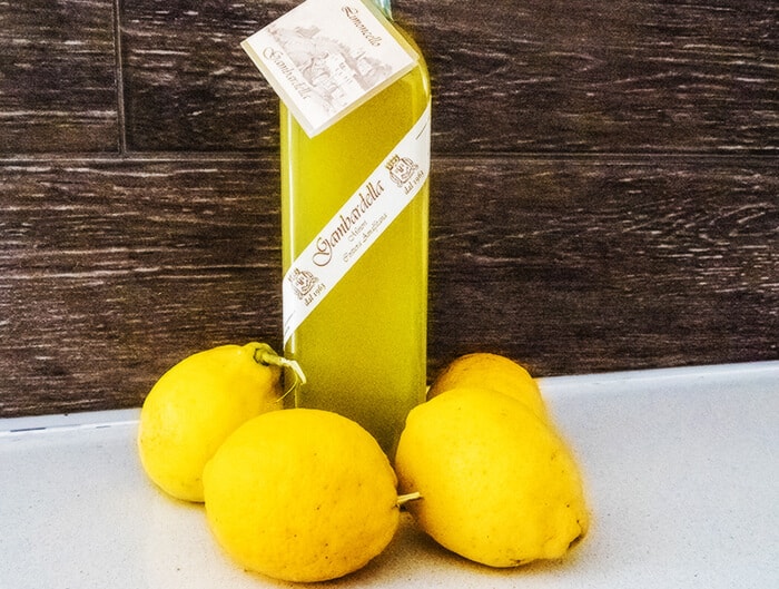 A bottle of Limoncello Gambardella with Amalfi lemons