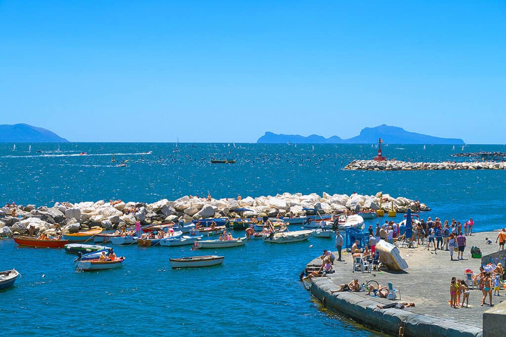 Fishermen's boats and people tanning in Naples