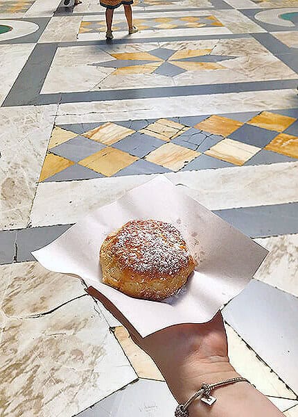 Dany holding sfogliatella frolla at Galleria Umberto in Naples