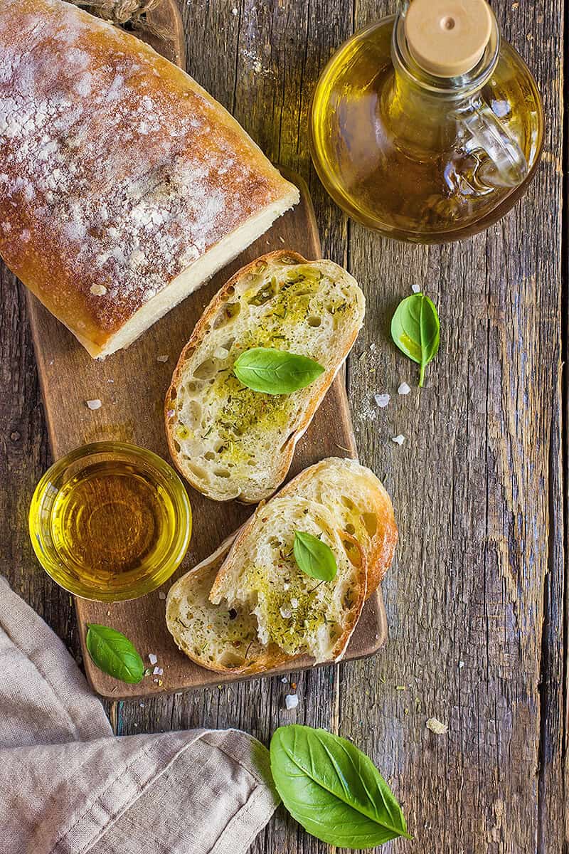 Bruschetta with olive oil and basil leaves