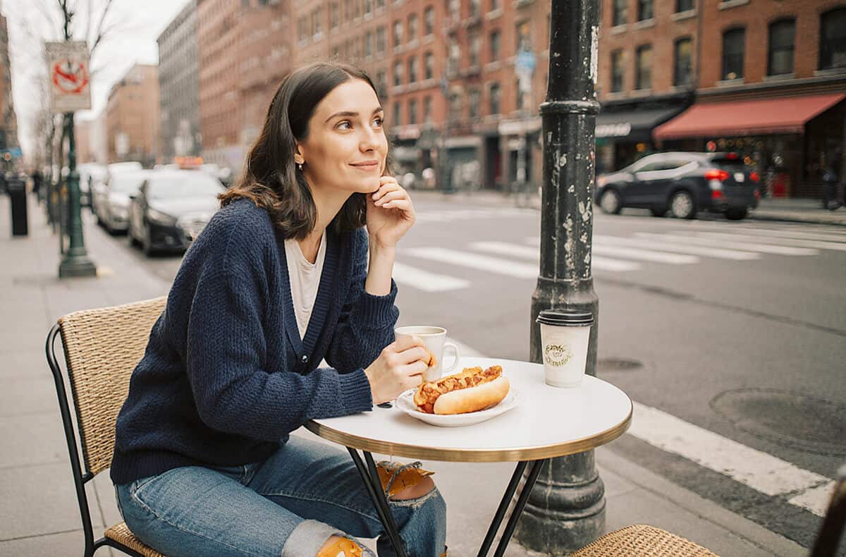Woman eating an hot dog in NYC